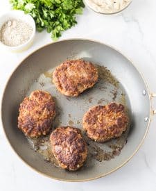 Slow Cooker Smothered Hamburgers cooked in frying pan