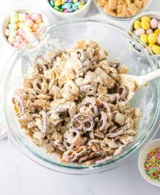 Process shot of bunny munch coated in almond bark in bowl