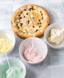 Easter Cookie Cake with the colored frostings in bowls