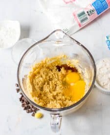 Easter Cookie Cake ingredients in mixing bowl with eggs and vanilla