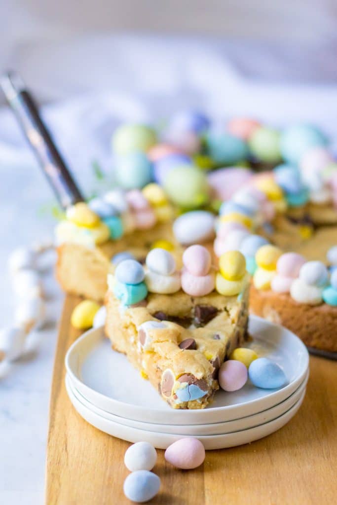 Easter Cookie Cake on a stack of plates on a board