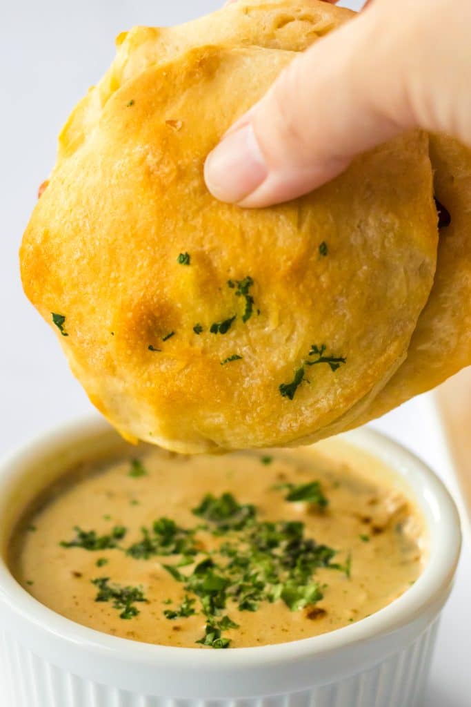 French Dip Biscuits being dipped into au jus