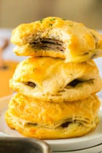 French Dip Biscuits stacked up with a bite taken out of one