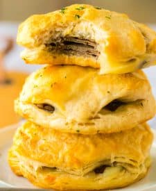 French Dip Biscuits stacked up with a bite taken out of one