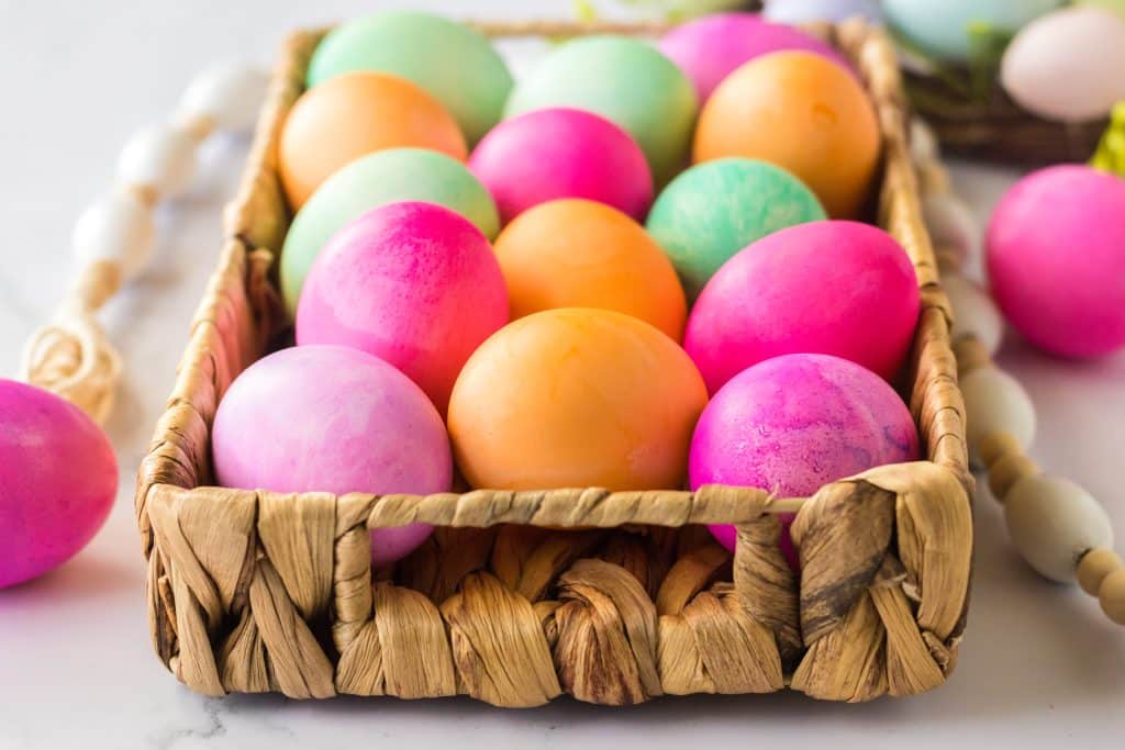 Brightly colored Slow Cooker Dyed Easter Eggs in a basket