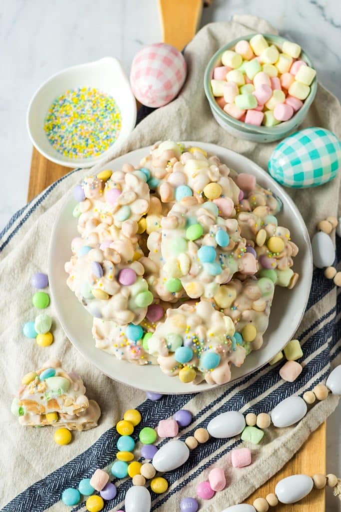 Slow Cooker Easter Candy piled on a plate with easter decor around it