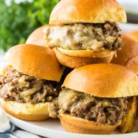 Slow Cooker French Dip Sloppy Joes on slider buns piled high on plate