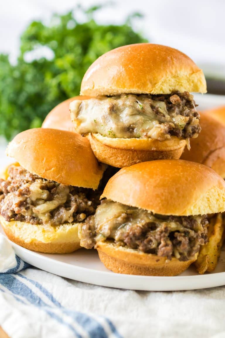 Slow Cooker French Dip Sloppy Joes on slider buns piled high on plate