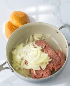 Slow Cooker French Dip Sloppy Joes beef and onion in a pan