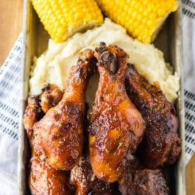 Slow Cooker Honey BBQ Drumsticks piled high with mashed potatoes and corn on the cob
