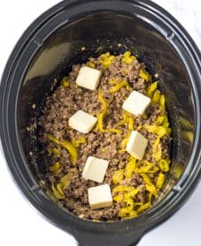 Slow Cooker Mississippi Sloppy Joes in slow cooker with pepperoncinis and butter