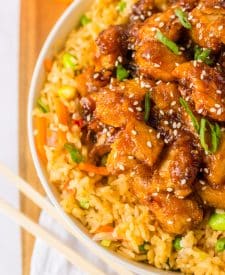 Slow Cooker Orange Chicken piled in a white bowl