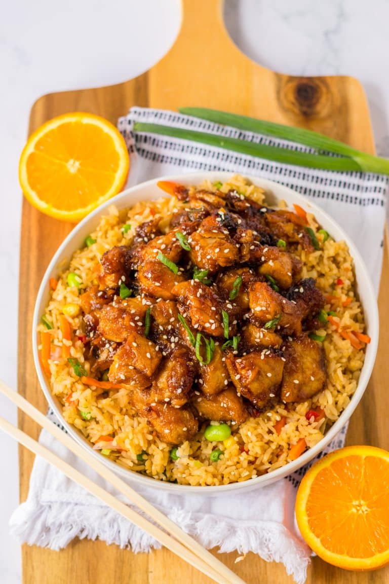 Slow Cooker Orange Chicken piled in a white bowl