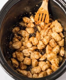 Slow Cooker Orange Chicken in slow cooker mixed with sauce