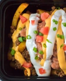 Copycat Taco Bell Nacho Supreme Fries close up with nacho cheese and sour cream