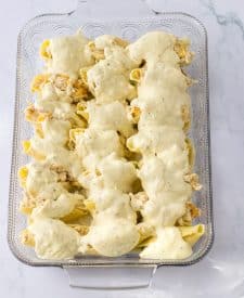 Crack Chicken Stuffed Shells in pan with sauce over