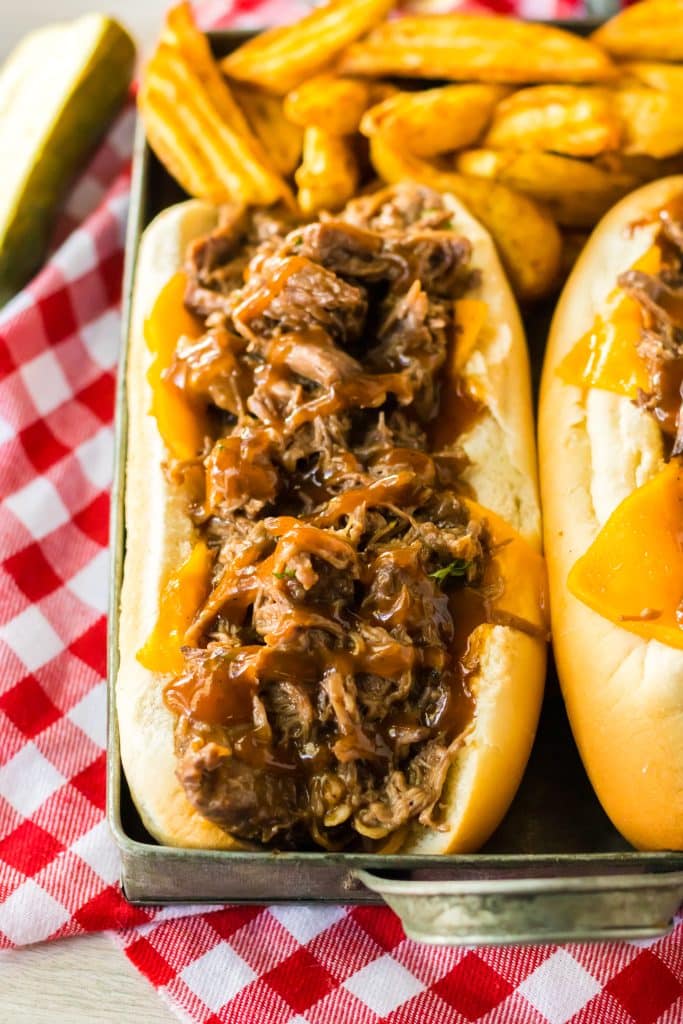 Slow Cooker BBQ Beef Sandwiches in a tray with fries
