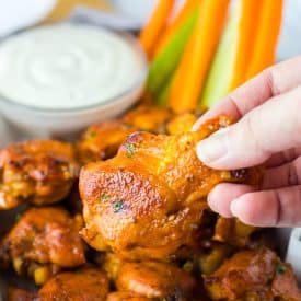 Close up of Slow Cooker Buffalo Ranch Chicken Wings being held