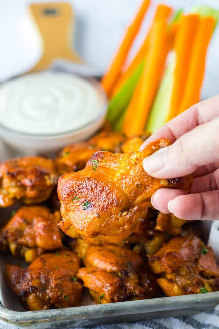 Close up of Slow Cooker Buffalo Ranch Chicken Wings being held