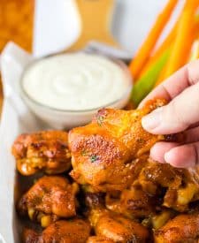 Slow Cooker Buffalo Ranch Chicken Wings being held