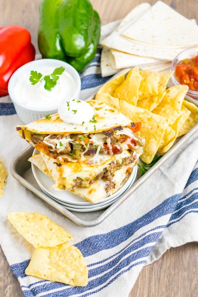 Slow Cooker Cheesesteak Quesadillas stacked on plate