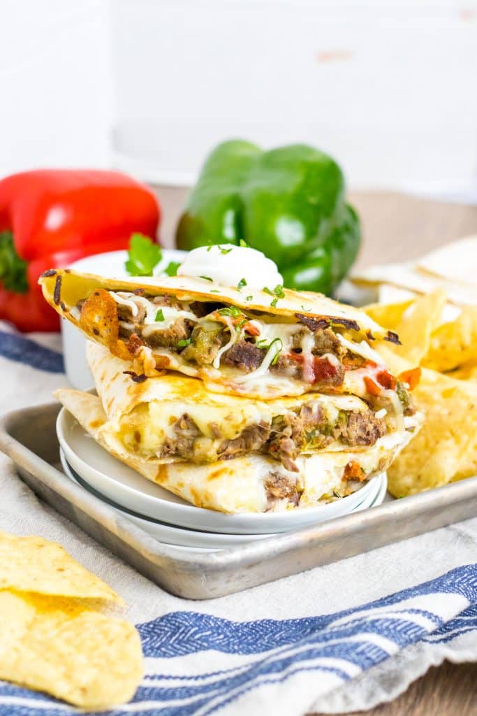 Slow Cooker Cheesesteak Quesadillas stacked on plate