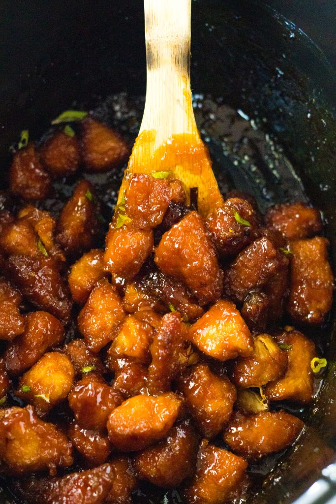 Slow Cooker Firecracker Chicken being spooned out of slow cooker