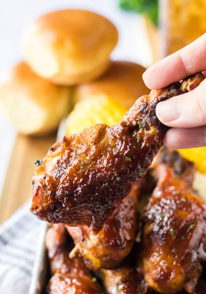 Slow Cooker Honey BBQ Drumsticks being held