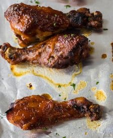 Slow Cooker Honey BBQ Drumsticks glazed on a sheet pan