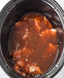 Slow Cooker Honey Peach Country Ribs in slow cooker with sauce