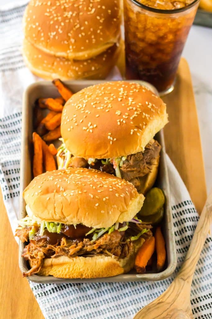 Slow Cooker Root Beer Pulled Pork piled on a bun with coleslaw