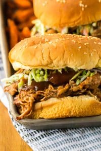 Slow Cooker Root Beer Pulled Pork piled on a bun with coleslaw