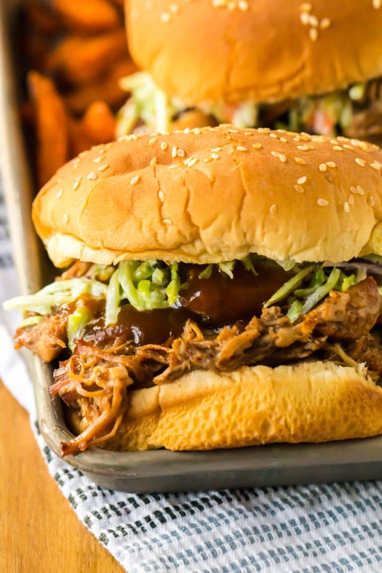 Slow Cooker Root Beer Pulled Pork piled on a bun with coleslaw