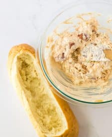 Mississippi Sin Dip ingredients in bowl with hollowed out bread