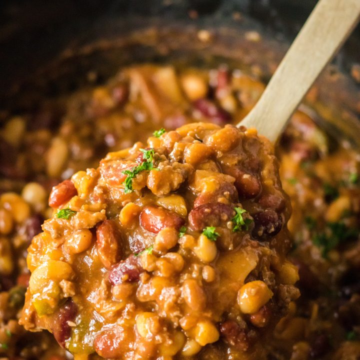 Slow Cooker Cowboy Beans in slow cooker in spoon