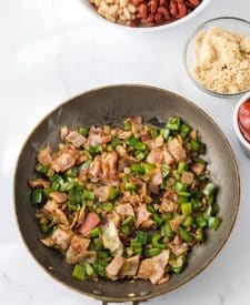 Slow Cooker Cowboy Beans bacon and peppers in pan