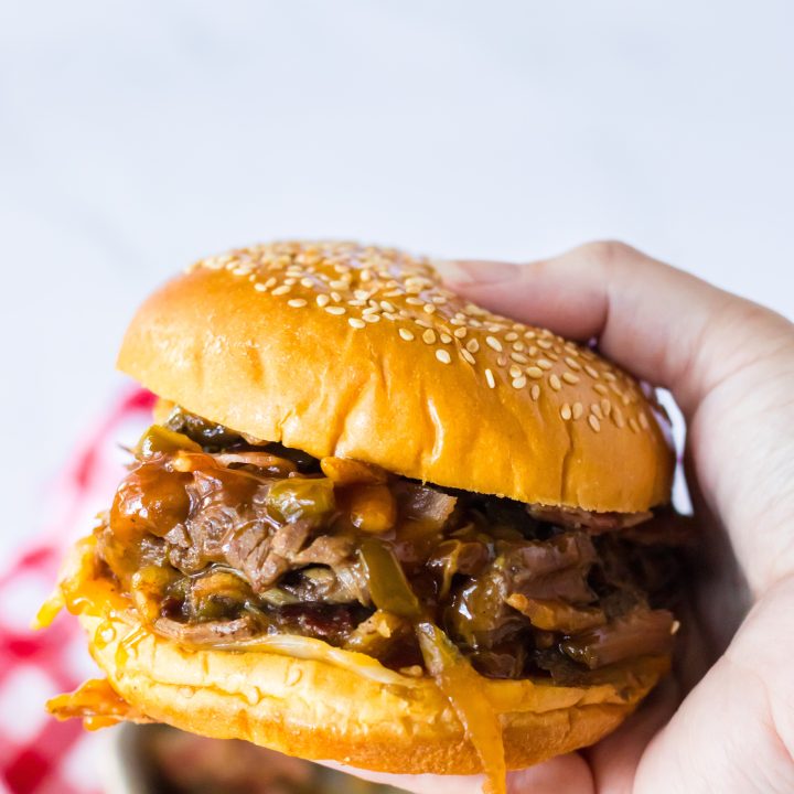 Slow Cooker Cowboy Beef Sandwiches in hand