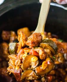 Slow Cooker Kung Pao Chicken being spooned out of slow cooker