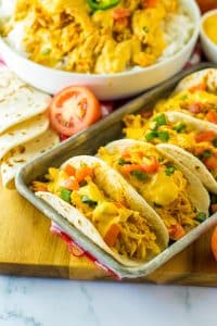 Slow Cooker Queso Chicken tacos on tray