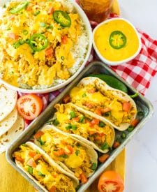 Slow Cooker Queso Chicken tacos on tray