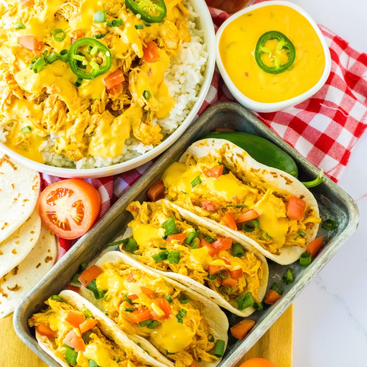 Slow Cooker Queso Chicken tacos on tray