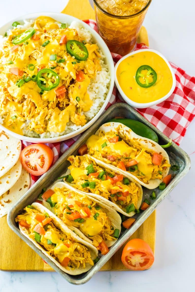 Slow Cooker Queso Chicken tacos on tray