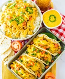 Slow Cooker Queso Chicken tacos on tray