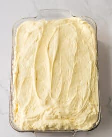 Ultimate Banana Pudding Poke Cake in pan with pudding layer