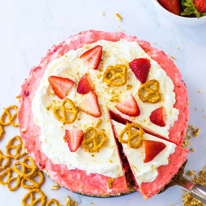 No Bake Strawberry Pretzel Pie with a slice coming out