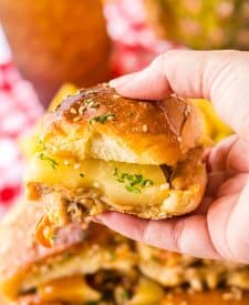Slow Cooker Hawaiian Chicken Sliders held in hand
