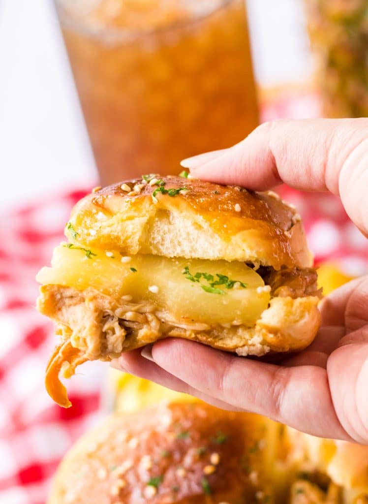 Slow Cooker Hawaiian Chicken Sliders held in hand