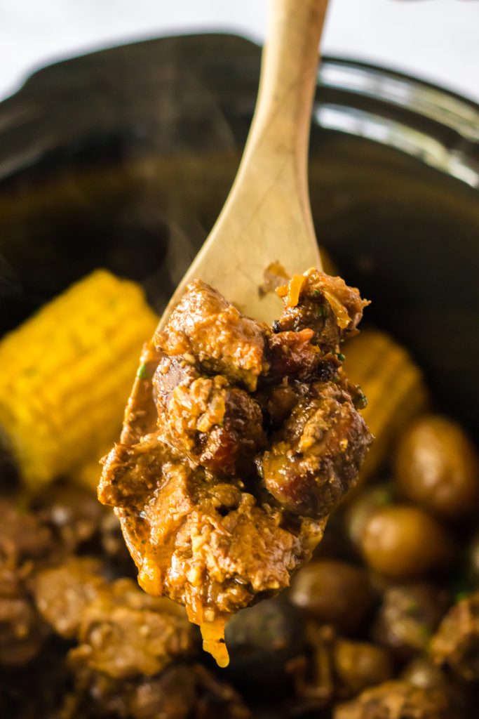Slow Cooker Steak, Potatoes and Corn in spoon