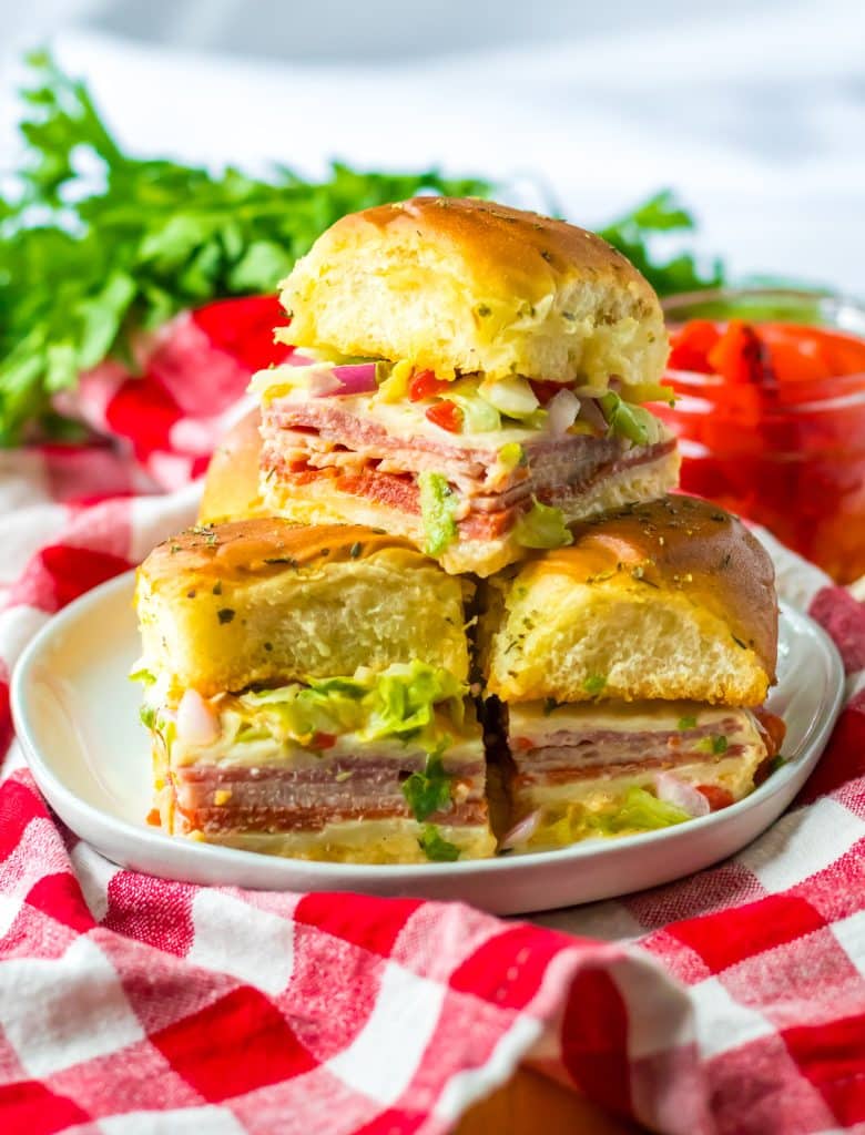 Baked Italian sub sliders with melted cheese, deli meats, and golden Hawaiian rolls