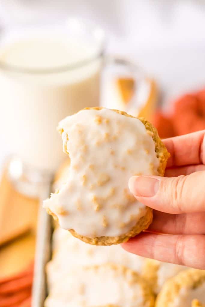 Old Fashion Iced Oatmeal Cookies in hand with bite taken